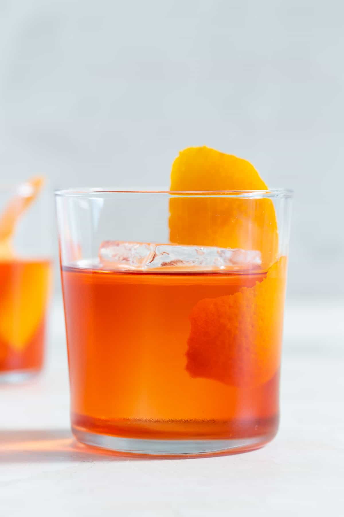 Close-up of a Negroni in a glass with an orange peel